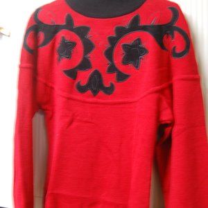 RED PULLOVER SWEATER W/ BLACKSUEDE FLORAL -LIKE DESIGN ON FRONT AND BLACK COLLAR